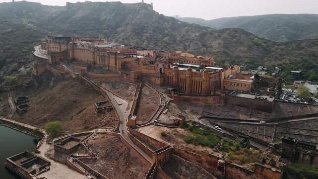 Aerial view of the historic amber fort, amer palace, and maota lake in jaipur, rajasthan, showing ancient indian architecture