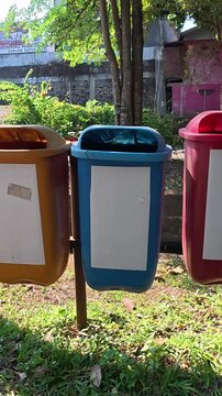 Color coded waste sorting bins in Yogyakarta public park