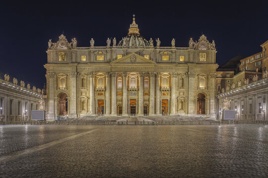 Citta del Vaticano, Vatican City - 15 October 2021: View of Saint Peter's Basilica at night with illuminated facade and empty cobblestone square.