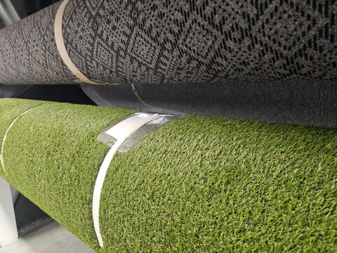 Rolls of carpet and artificial grass in a store display