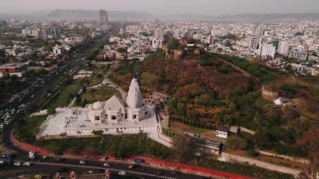 Aerial view of birla mandir temple in jaipur with city traffic and moti doongri fort in the background