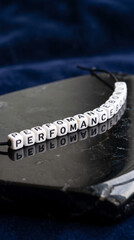 Naklejka premium White letter bead necklace spelling 