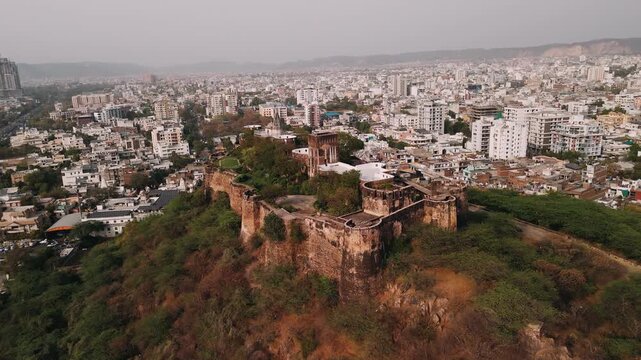 Aerial view of moti doongri fort on a hilltop overlooking the modern city of jaipur, rajasthan, india