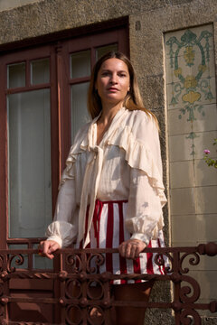 Woman Standing by a Balcony in a Park