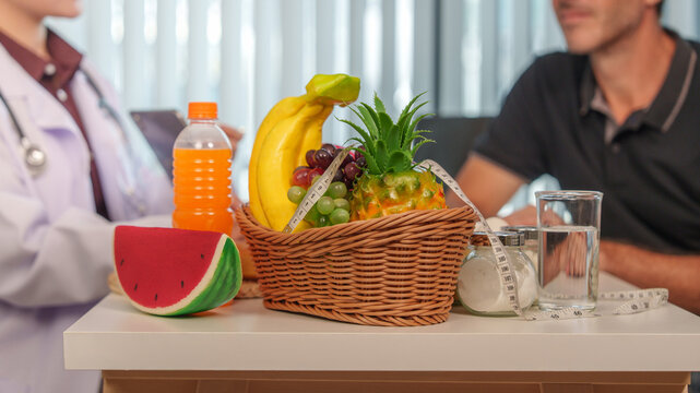 Nutrition consultant explaining healthy diet plan to male patient in office