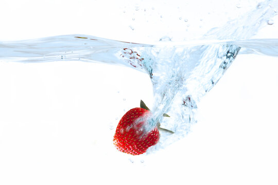 Strawberry splashing into water