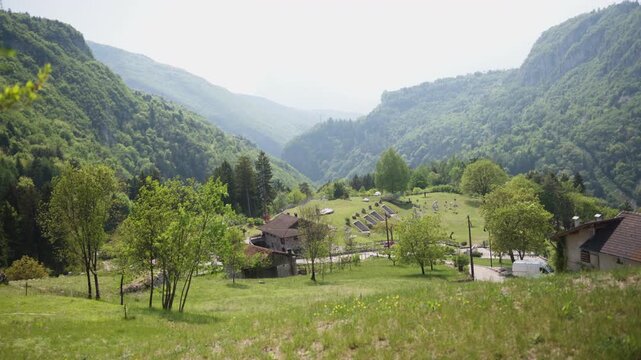 Panoramic wide shot of the lush rural landscape and green meadows in Moline, Italy. Scenic countryside view during a bright summer day.