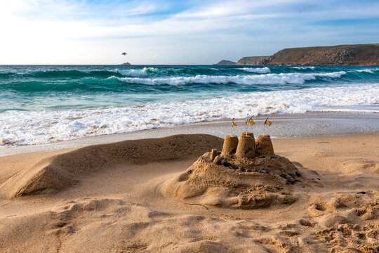 A sandcastle stands on the beach at Whitesand Bay in Cornwall
