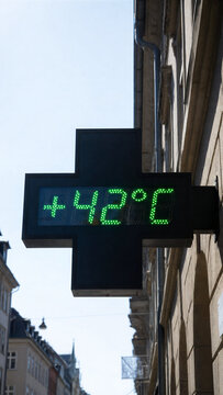 Pharmacy cross sign displaying 42 degrees temperature in a heatwave