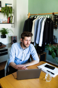 Male freelancer takes a break from remote work at home office