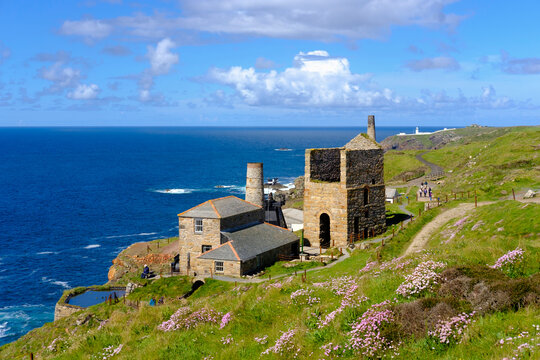 UK, Cornwall, Old tin and copper mine with Pendeen lighthouse in background