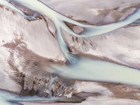 Aerial view of glacial braided river with turquoise meltwater in Iceland