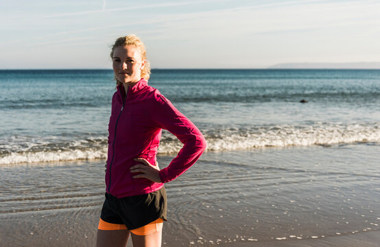 France, Crozon peninsula, sportive teenage girl standing on the beach