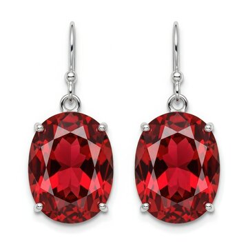 Oval red gemstone stud earrings with silver posts isolated on white background