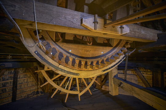 Waarland, Netherlands - 25 November 2022: View of the intricate wooden gear mechanism inside the historic Slootgaarpolder mill, showcasing traditional craftsmanship.