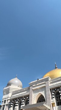 Golden domed mosque rising beneath clear Yogyakarta sky