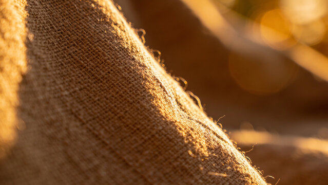 Close up of burlap sack texture in warm golden sunlight