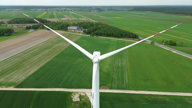 Powerful wind generator on beautiful green field