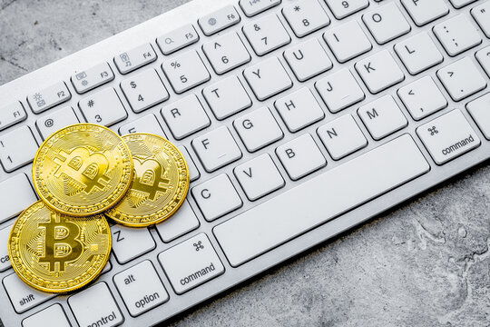 Bitcoin on keyboard for online payment on gray background