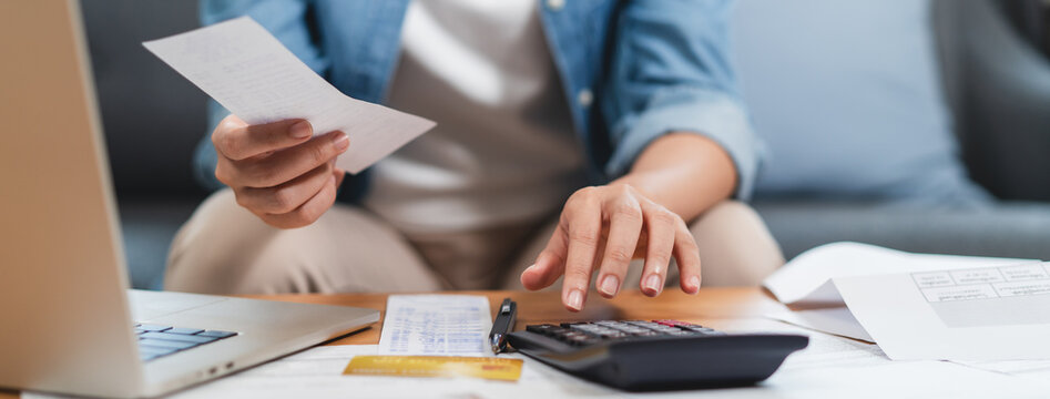 Woman doing accounting home finance expenses and calculate credit card monthly debt to bills payment