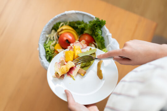 Food waste environment concept, people throwing food garbage into bin prepare to decompose