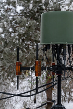 Tactical electronic warfare or communication antenna mounted on a tripod in snow