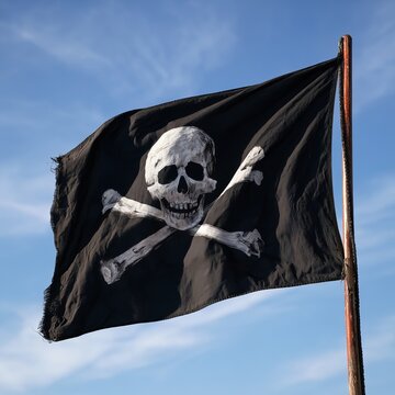 Black pirate flag featuring a skull and crossbones flutters in the wind.
