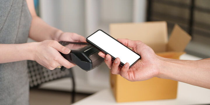 Customer making contactless mobile payment using smartphone on POS terminal for digital transaction