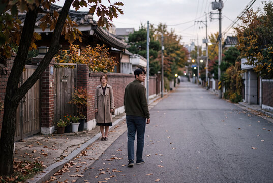 Couple walking on a quiet autumn street in a residential neighborhood for moody background and scene composition