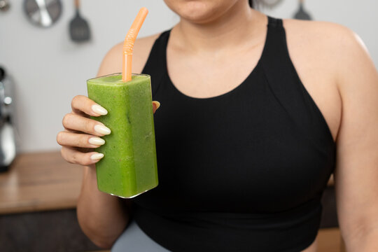 Woman drinking Green smoothie detox, or diet inspiration. vegan or fruit drink for nutrition