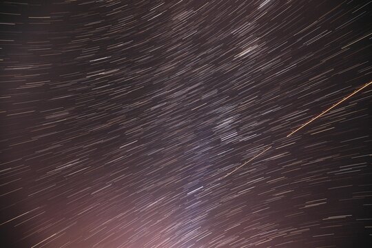 5k Bewitching Illusion Of Star Trails. Rotate Of Sky Background. Spin Of Unusual Amazing Stars Effect In Sky. Meteors Trace On Night Dark Blue Sky Background. ,