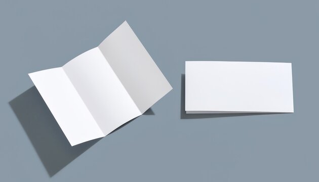 White tri-fold flyer and card mockup on blue-gray.