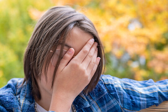 Stressed teenager, feeling pressure and isolation, boy, 13-year-old child in distress, mental fatigue, concept mental health, adolescence struggles, loneliness, outsider emotions, autumn background