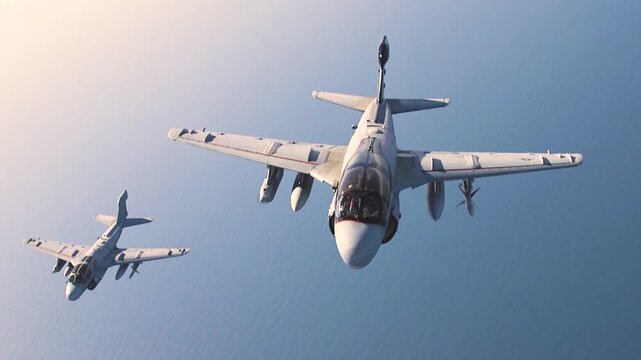 Two Military Attack Aircraft Flying Tactical Formation Over Open Ocean During Advanced Naval Aviation Training Exercise.