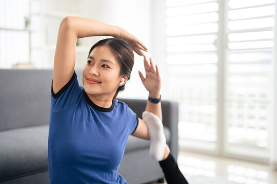 Young woman doing fitness exercises at home. healthy lifestyle concept