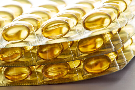 Stacked Blister Packs of Yellow Softgel Omega 3 Capsules