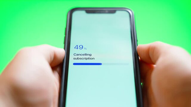 Hands holding smartphone with subscription cancellation progress and cancellation failed error