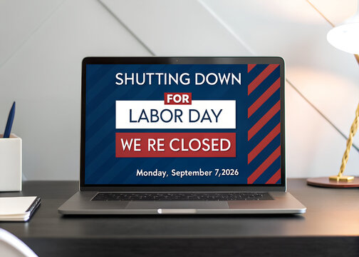 Laptop screen showing a labor day store closing announcement sign on a modern office desk