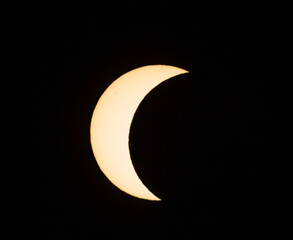 Solar eclipse phase on August 12, 2026, captured in Portugal. Thin crescent of the sun isolated on a black sky background. A rare astronomical celestial event shot © volff