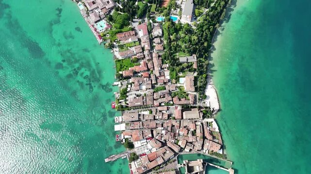 Aerial drone top view of Hel harbor and the old town waterfront on Hel Peninsula Poland featuring turquoise Baltic Sea marina boats historic buildings and sandy shoreline