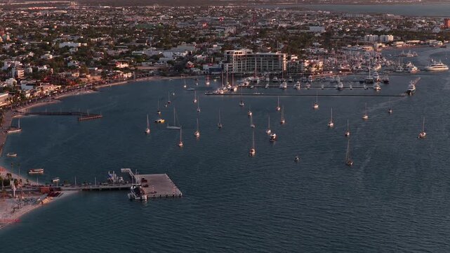 Aerial view of La Paz Malecon in Baja California Sur with sailboats in the bay at sunset.