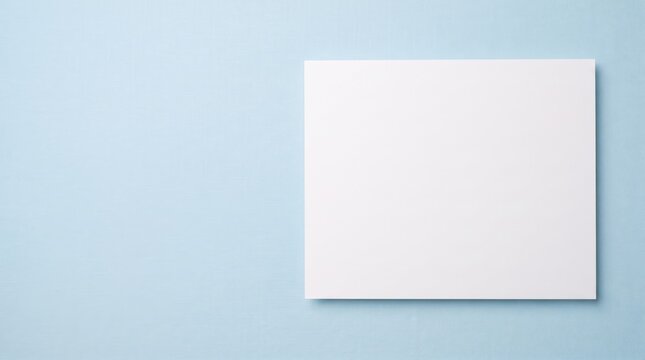 Blank smooth cardstock paper with clean edges on pastel blue surface for corporate design backgrounds