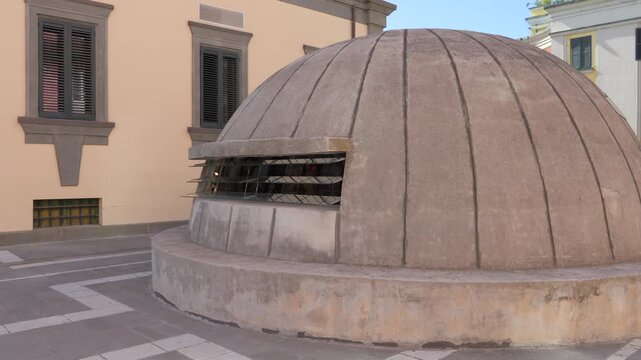 Concrete dome bunker entrance of Bunk&rsquo;Art 2 Museum with metal slatted window beside adjacent building in Tirana