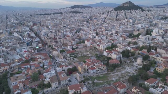 Roman Agora and Hadrian's Library sit within a packed urban grid as the camera circles overhead at blue hour in Greece