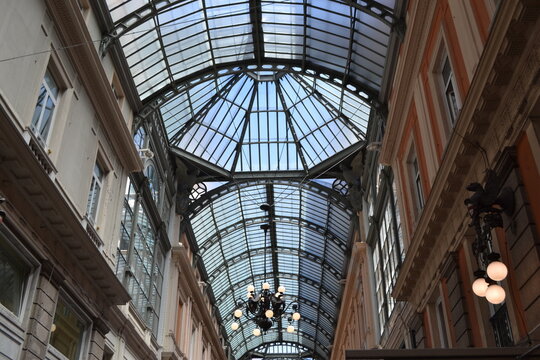 Glass vaulted arcade ceiling and chandeliers inside galleria mazzini in Genoa for architectural background and travel poster design
