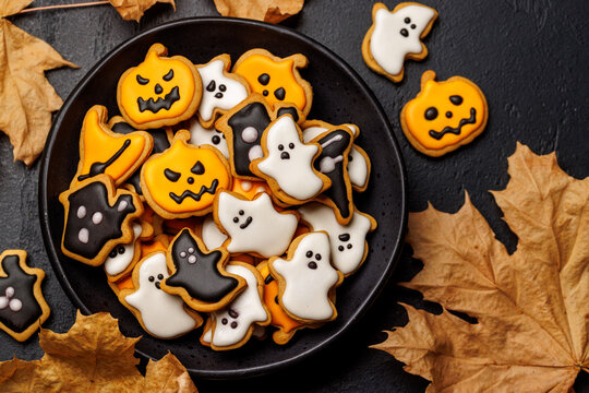 Halloween cookies on black stone background with copy space