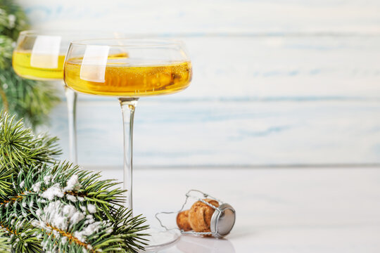 Champagne glasses and snowy fir