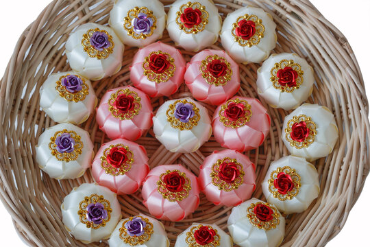 Handmade craft Thai festival decoration,Coins wrapped in floral ribbons on a basket against   background.