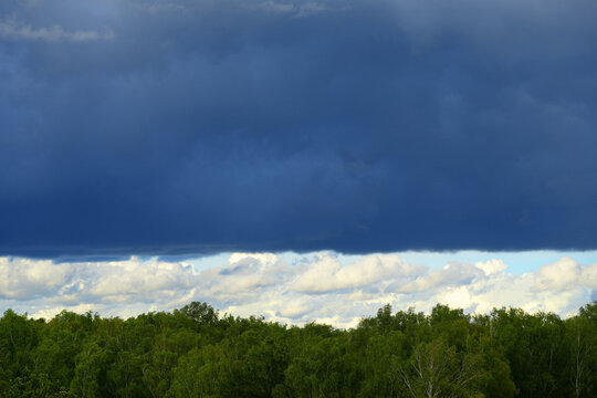 A cloud over the forest in summer