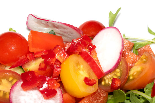 Close up of a delicious healthy side salad with leaves and radish on a white plate